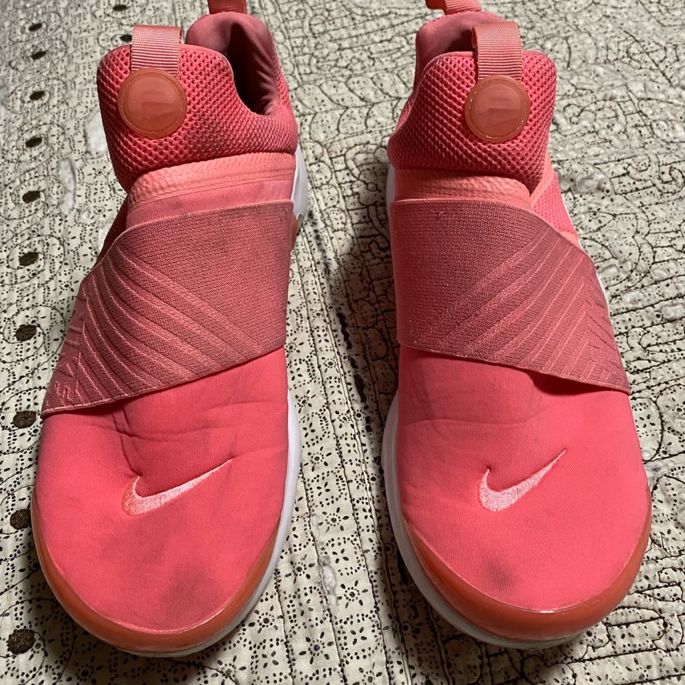 Nike coral slip on sneakers. Size is US-7Y; EUR-40; and UK-6.
